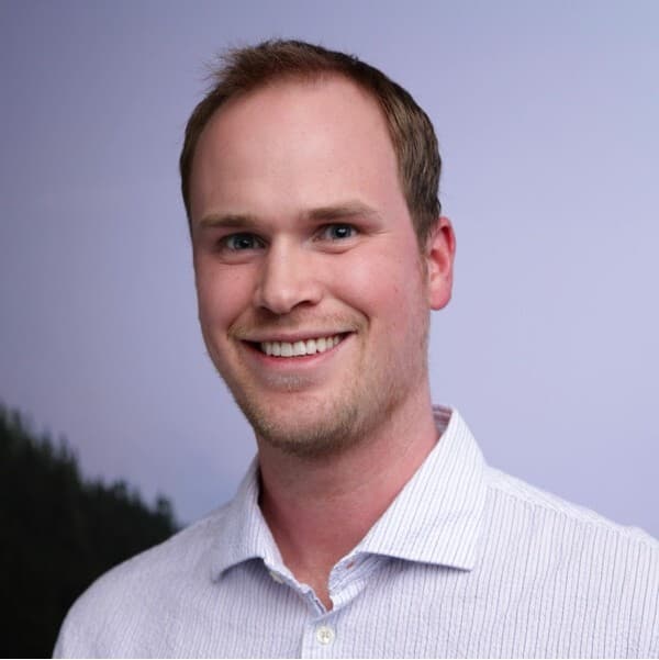 Mike Yerke smiling in a light button-down shirt